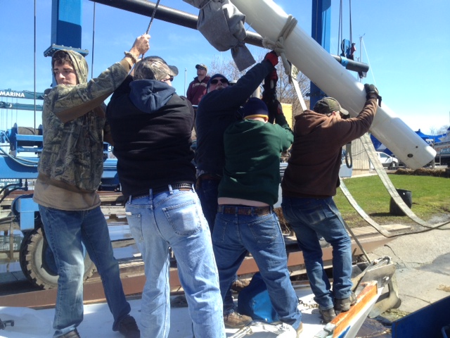 All hands on deck, putting up the mast